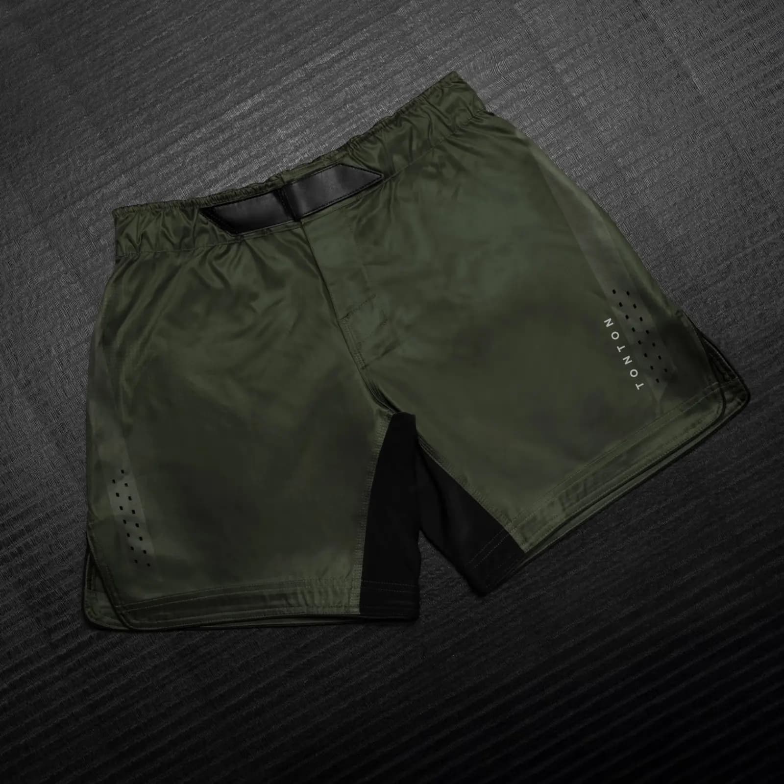 Olive green functional training shorts with perforated ventilation, contrast panels and adjustable waistband