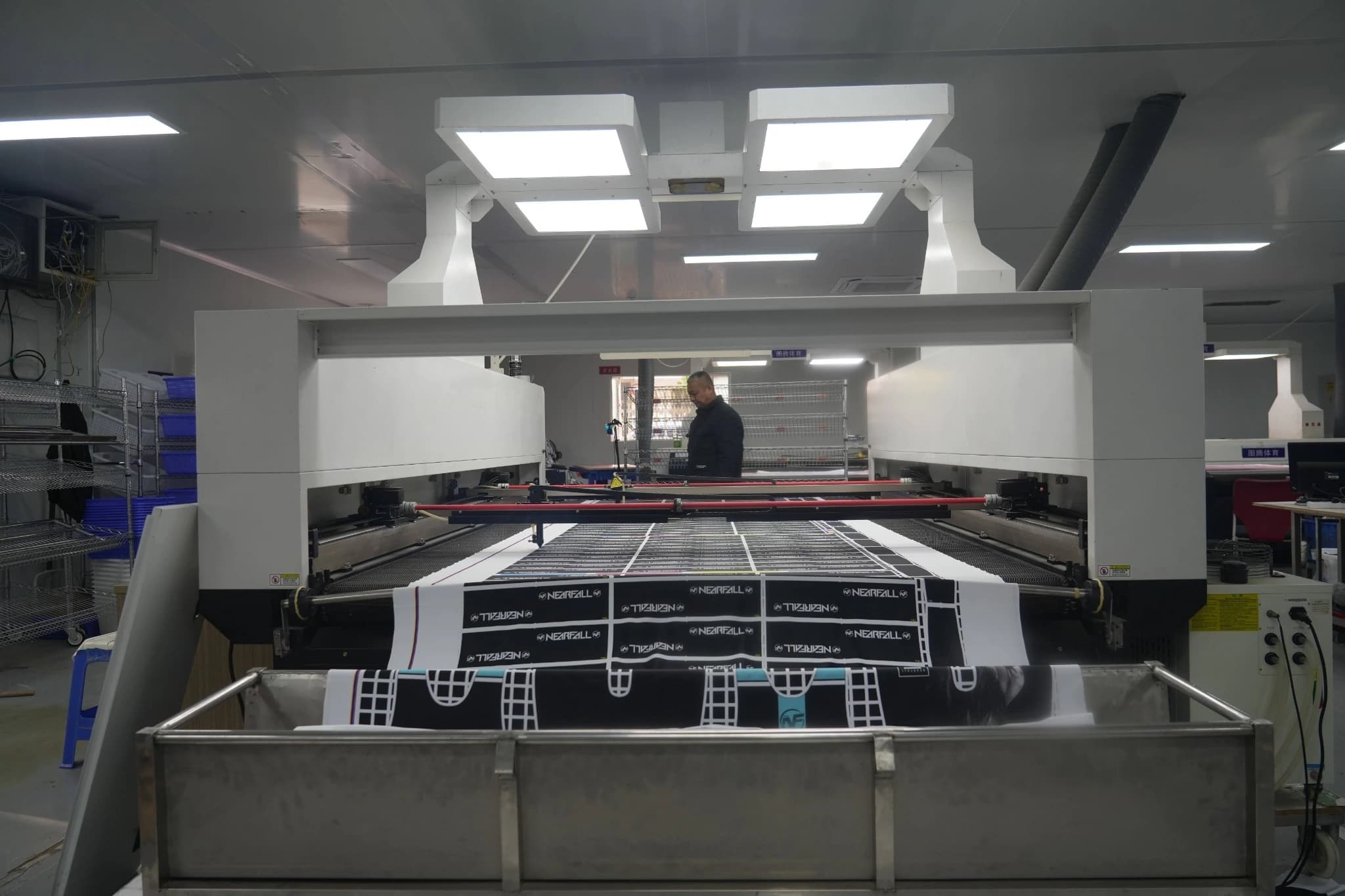 Garment panel shapes laid out on a computerized cutting table inside the TONTON workshop