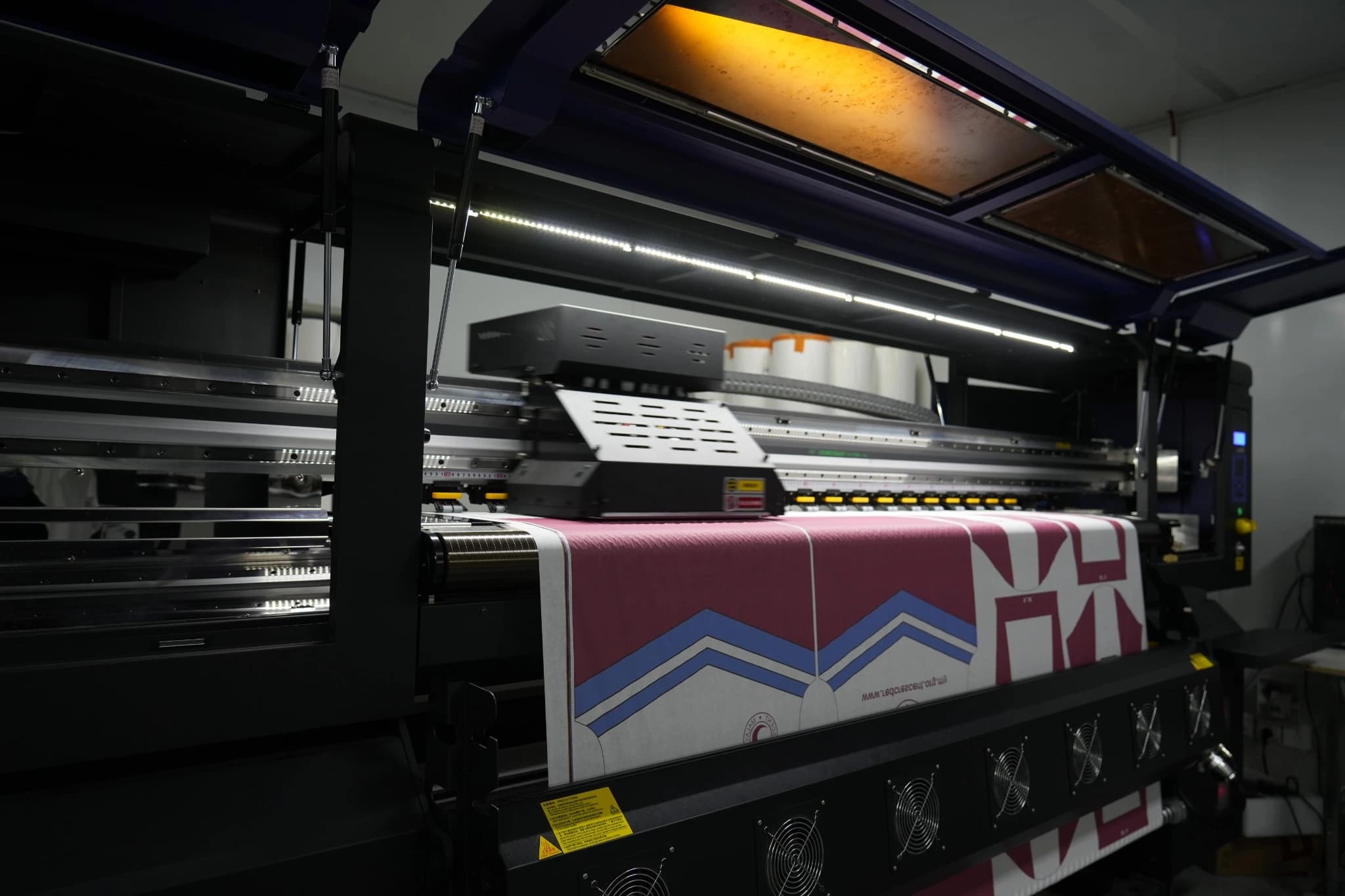 Contrasting red, blue and white artwork emerging from a TONTON sublimation printer