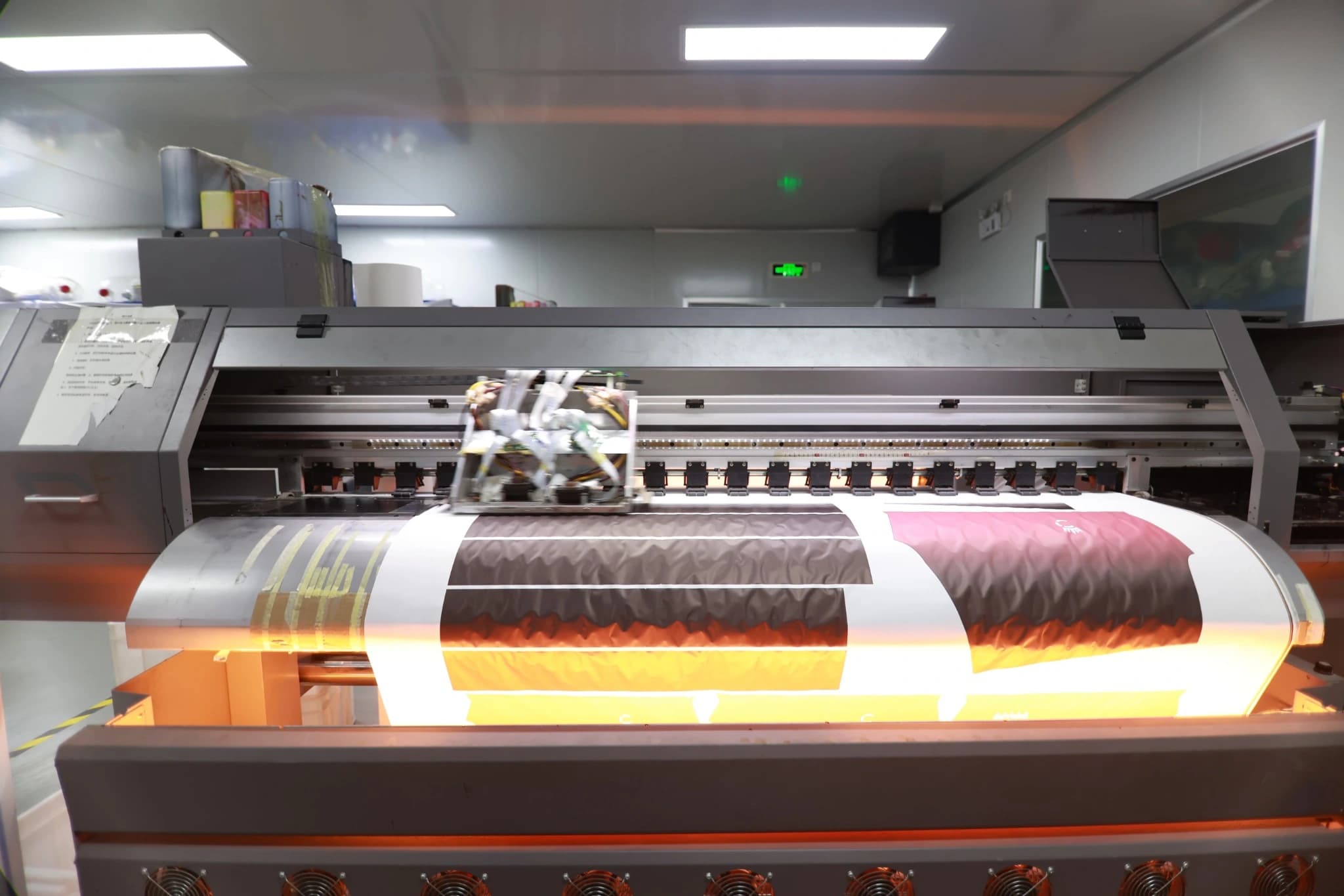 Front view of a TONTON roll-to-roll sublimation printer producing sportswear graphics