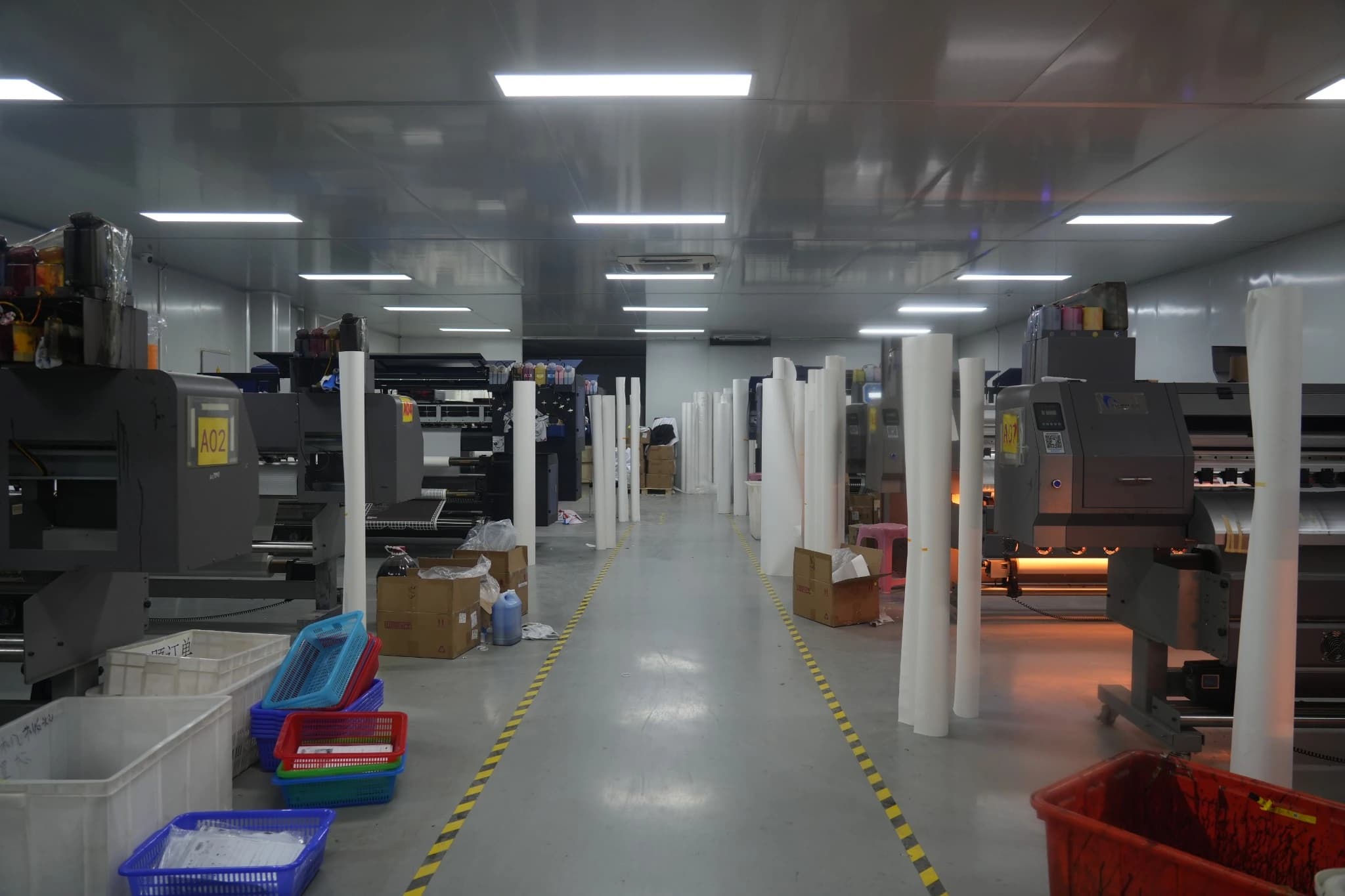 Central aisle through the TONTON digital printing workshop with equipment on both sides