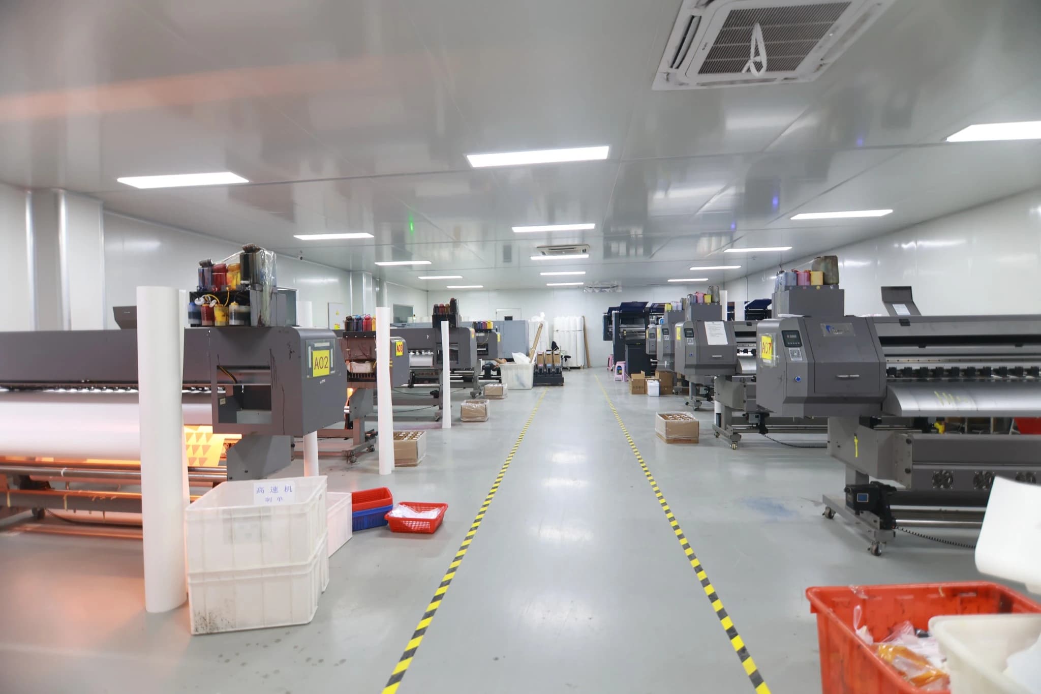 Rows of industrial roll-to-roll printing equipment in the TONTON workshop