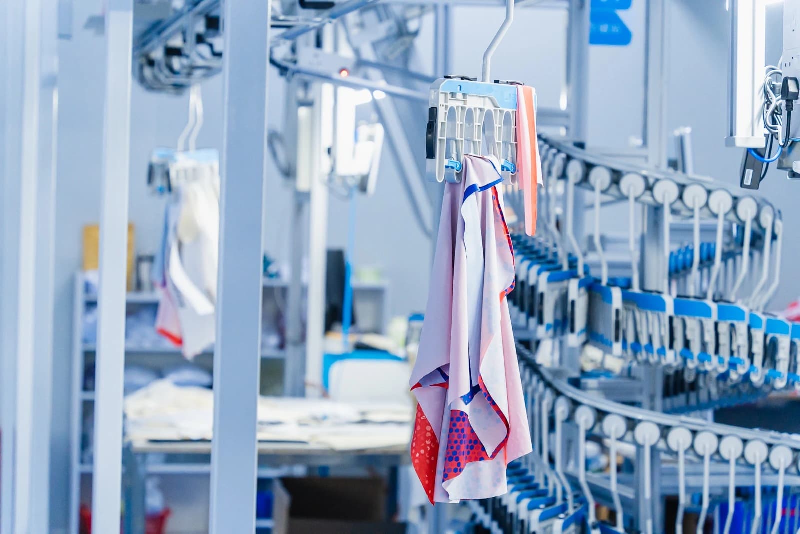 Sportswear fabric panels suspended from carriers on the hanging rail