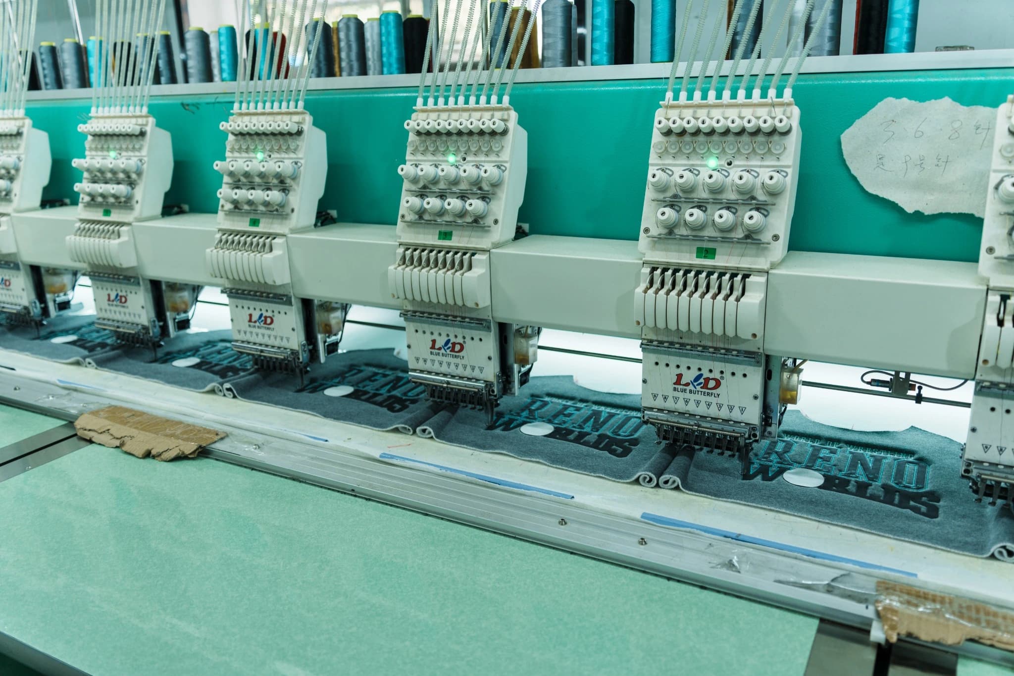 Front view of multiple JIAYU embroidery heads and their thread-tension controls