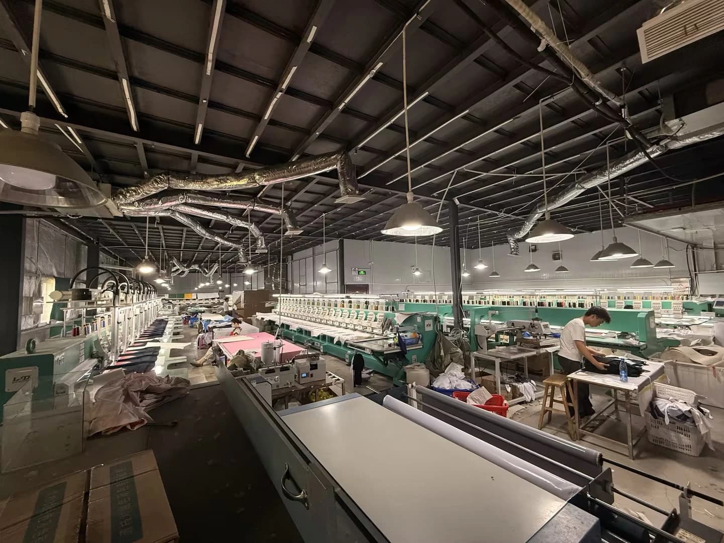 Wide view of embroidery machines and production tables in the TONTON workshop
