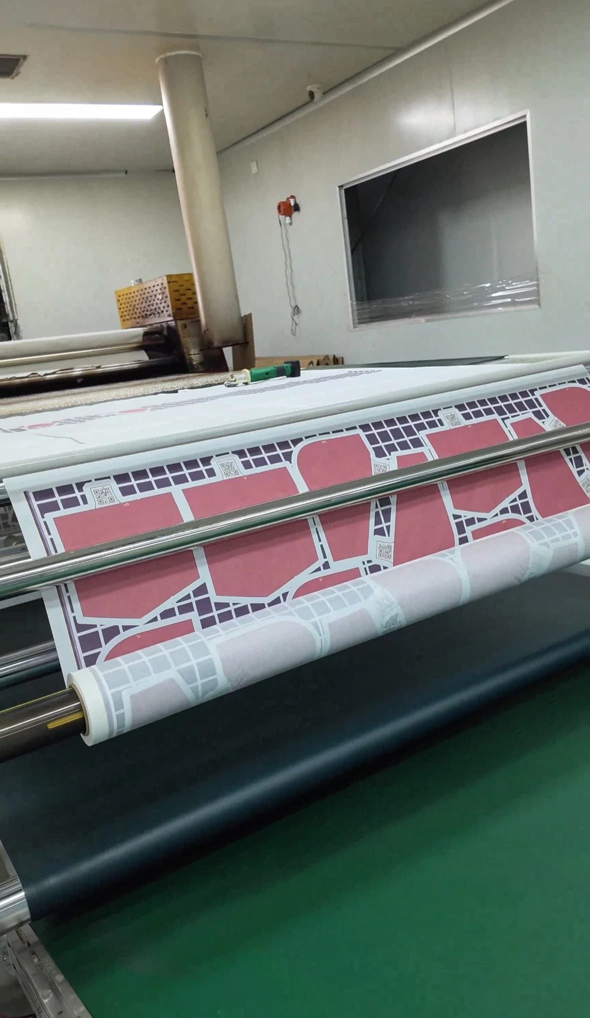 Sublimation paper carrying sportswear front, back and sleeve panel graphics at the rotary transfer machine
