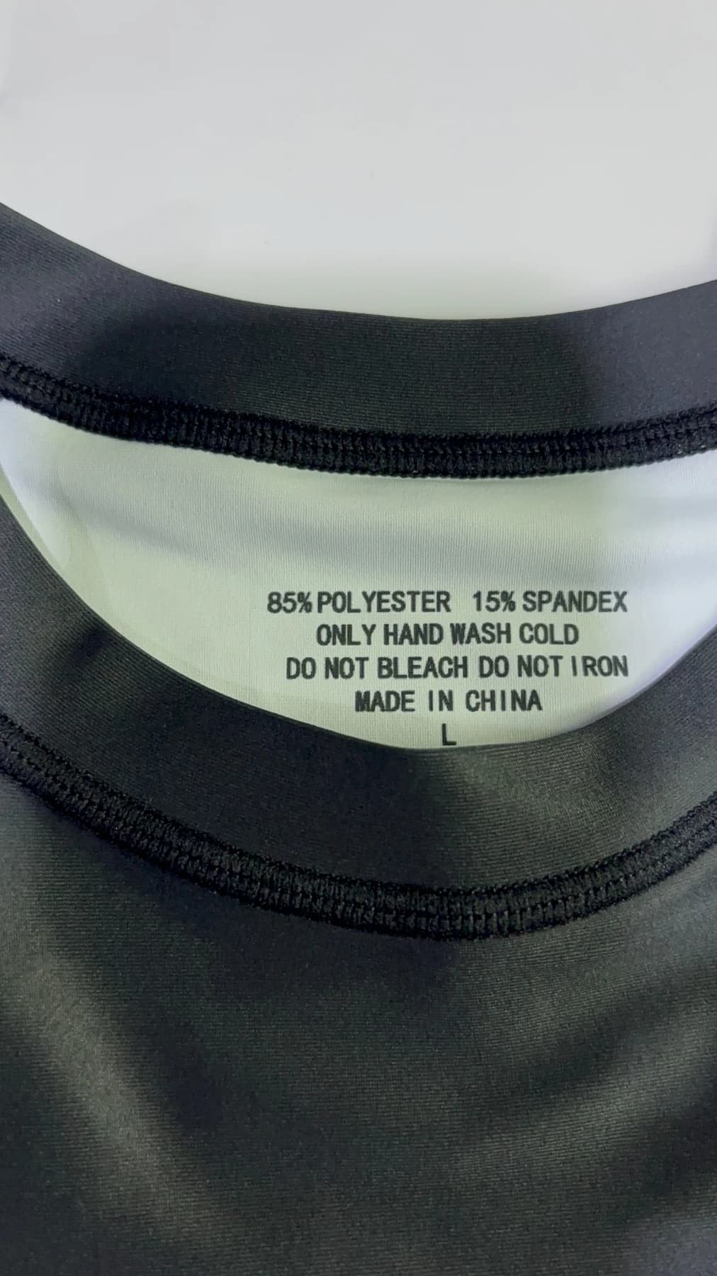 Garment neck label showing 85 percent polyester and 15 percent spandex