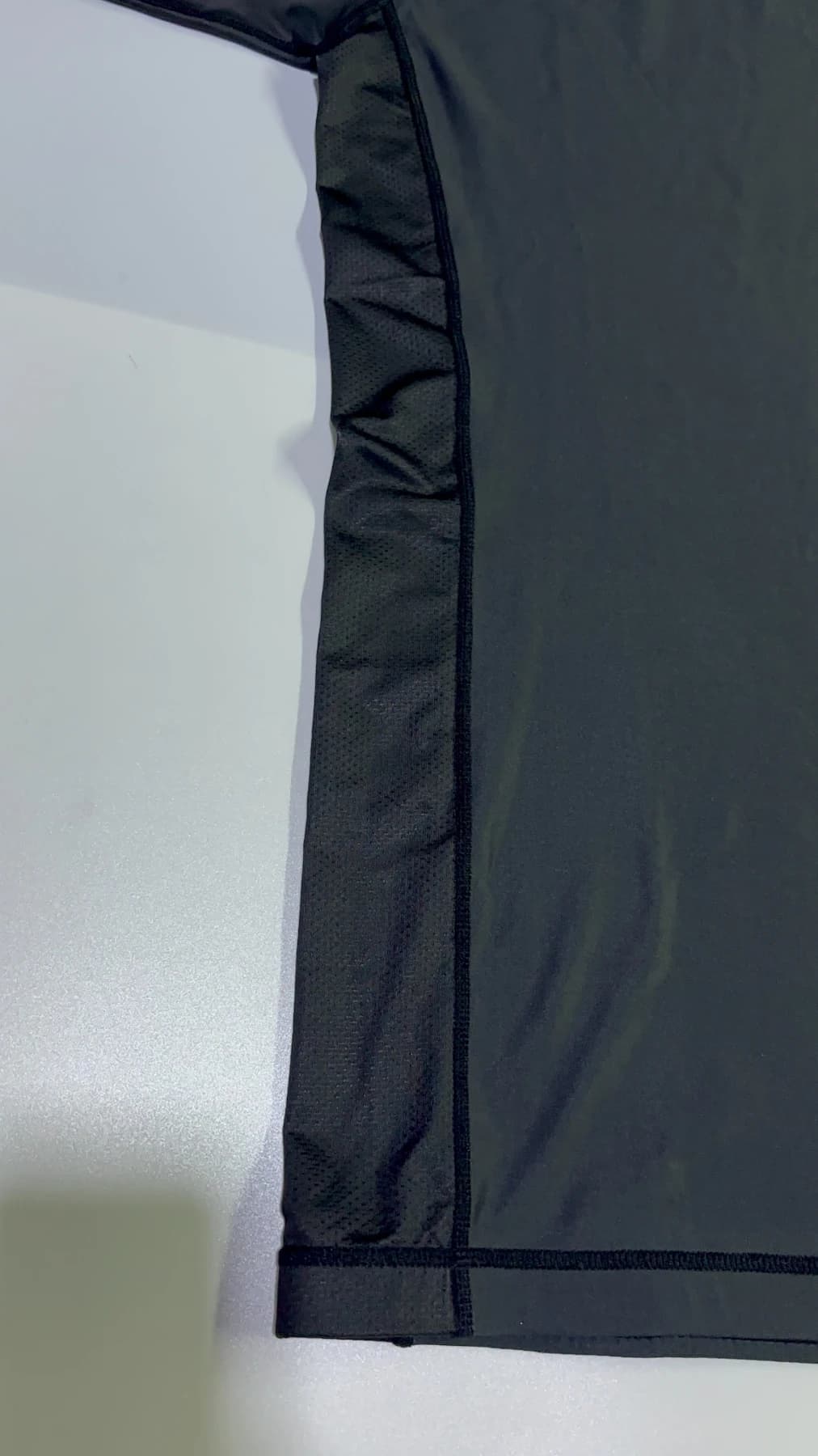 Smooth dark stretch-knit main fabric on the supplied rash guard