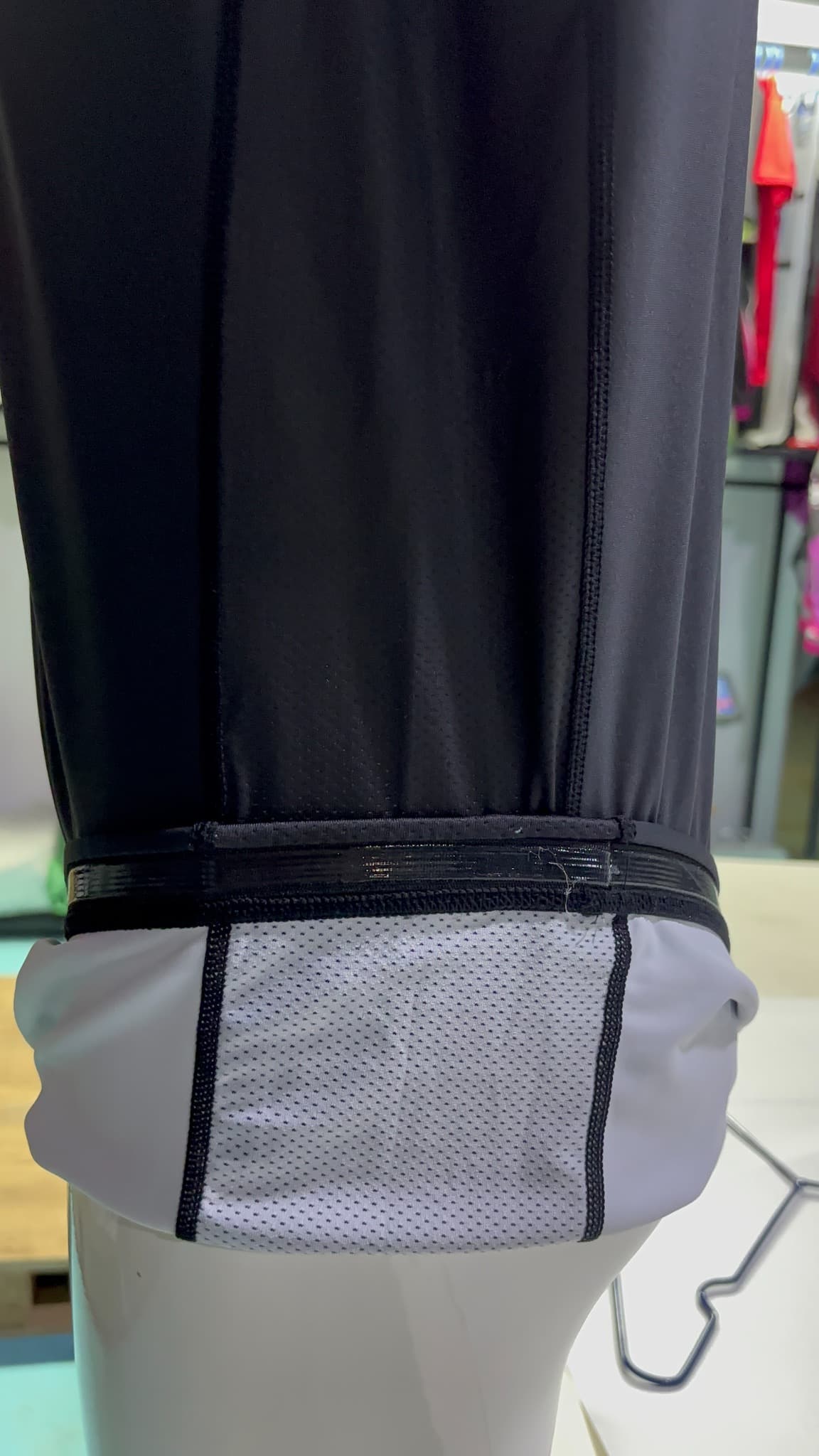Actual supplied inner garment view showing a light mesh panel, dark seam junctions and a separate elastic hem band