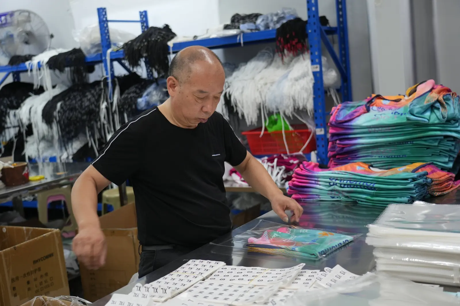 Finished custom sportswear being folded and packed