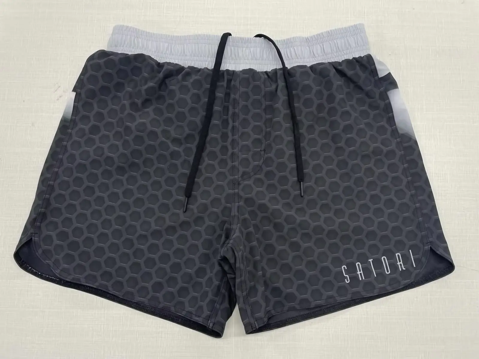 Customer-supplied grey honeycomb print two-in-one grappling shorts with white inner liner and drawstring waistband