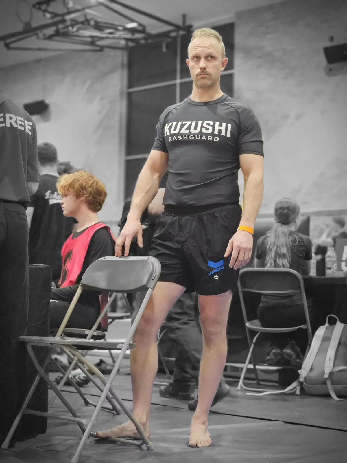 Customer athlete wearing a black Kuzushi short-sleeve Rash Guard at an event