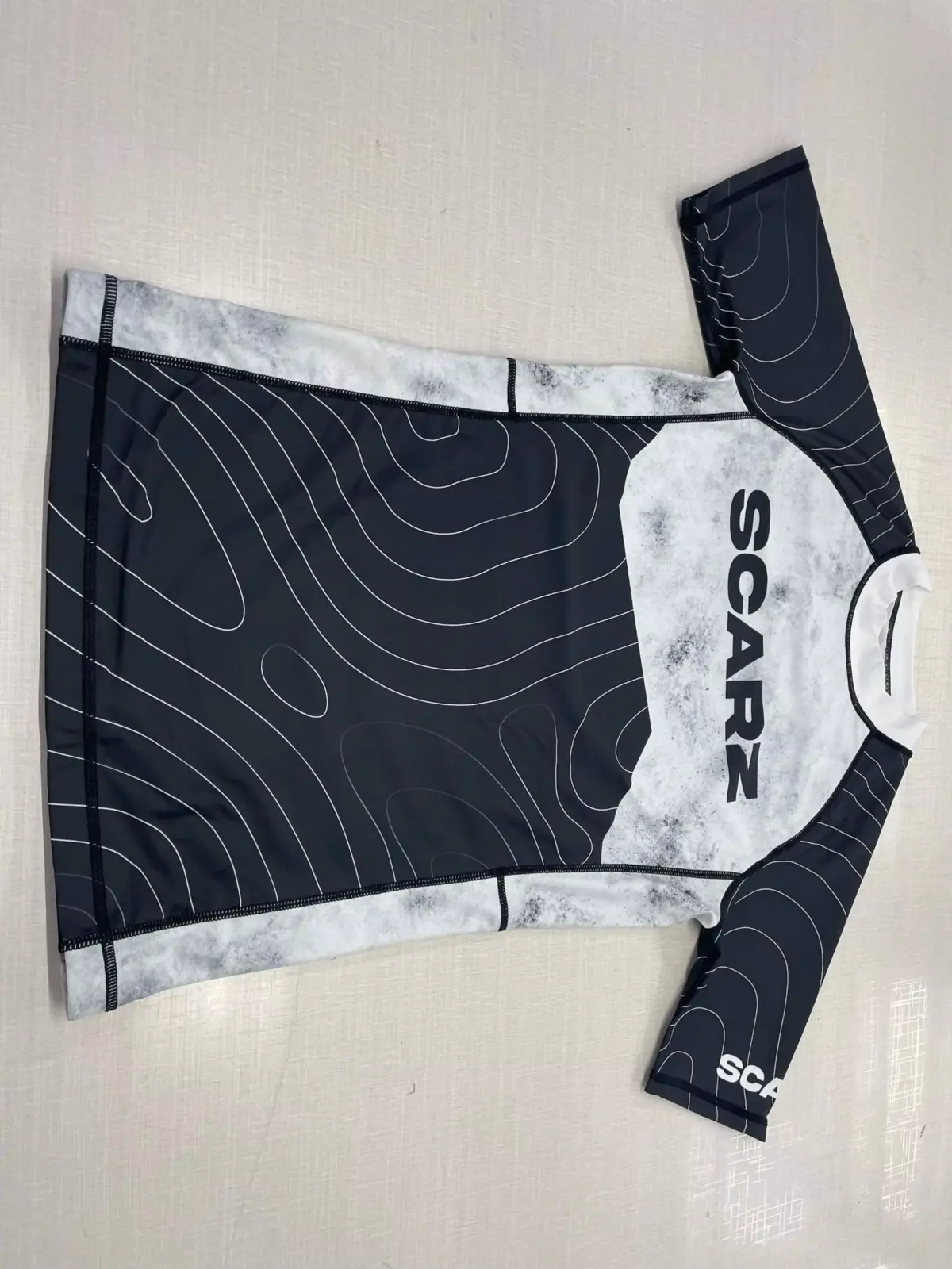 Customer-supplied photograph of a finished custom sublimated Rash Guard
