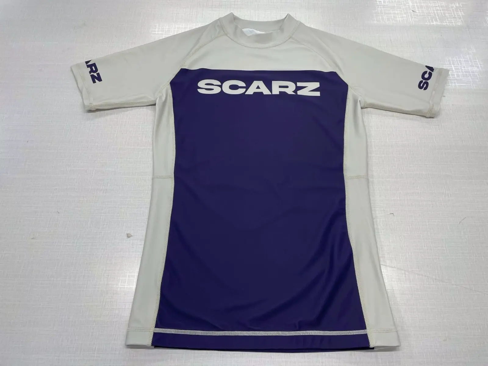 Customer-supplied back photograph of a finished white and purple Scarz long-sleeve custom Rash Guard with Argentina graphics