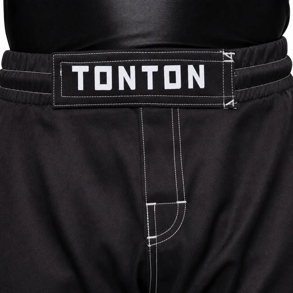 Elastic waistband, sewn TONTON patch and reinforced crotch detail on black MMA fight shorts