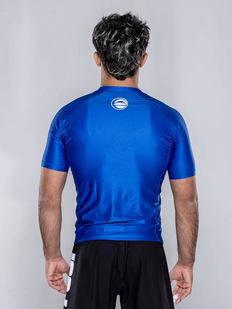 Back view of the blue Elite Team Rash Guard showing rear panel and neck branding
