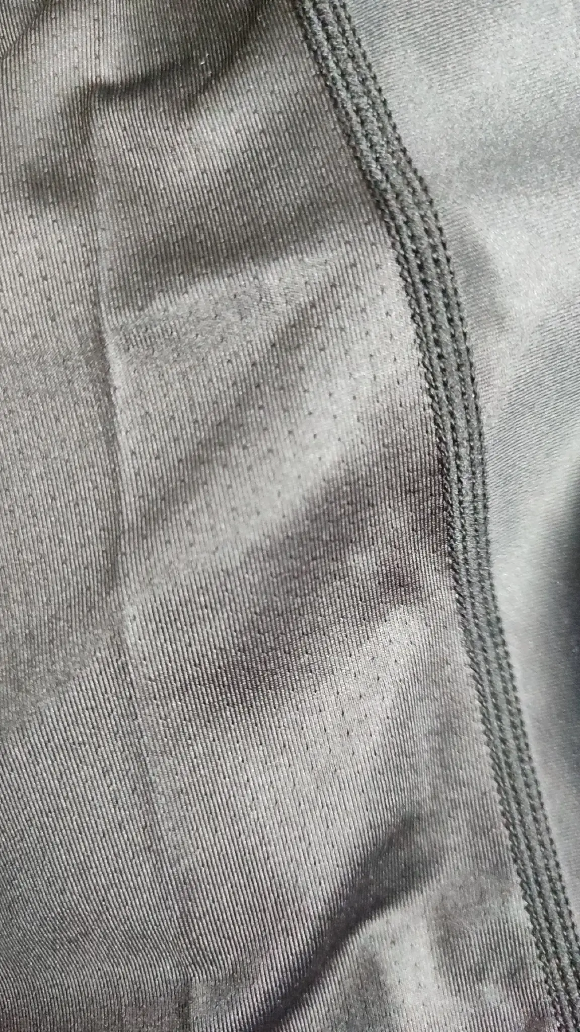 Close-up of stretch Rash Guard fabric with parallel seam construction