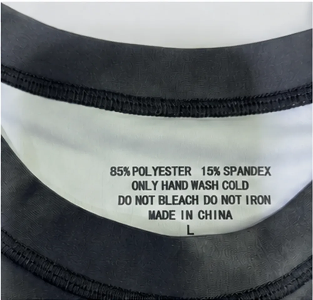 Printed neck label on a Rash Guard sample showing 85 percent polyester and 15 percent spandex