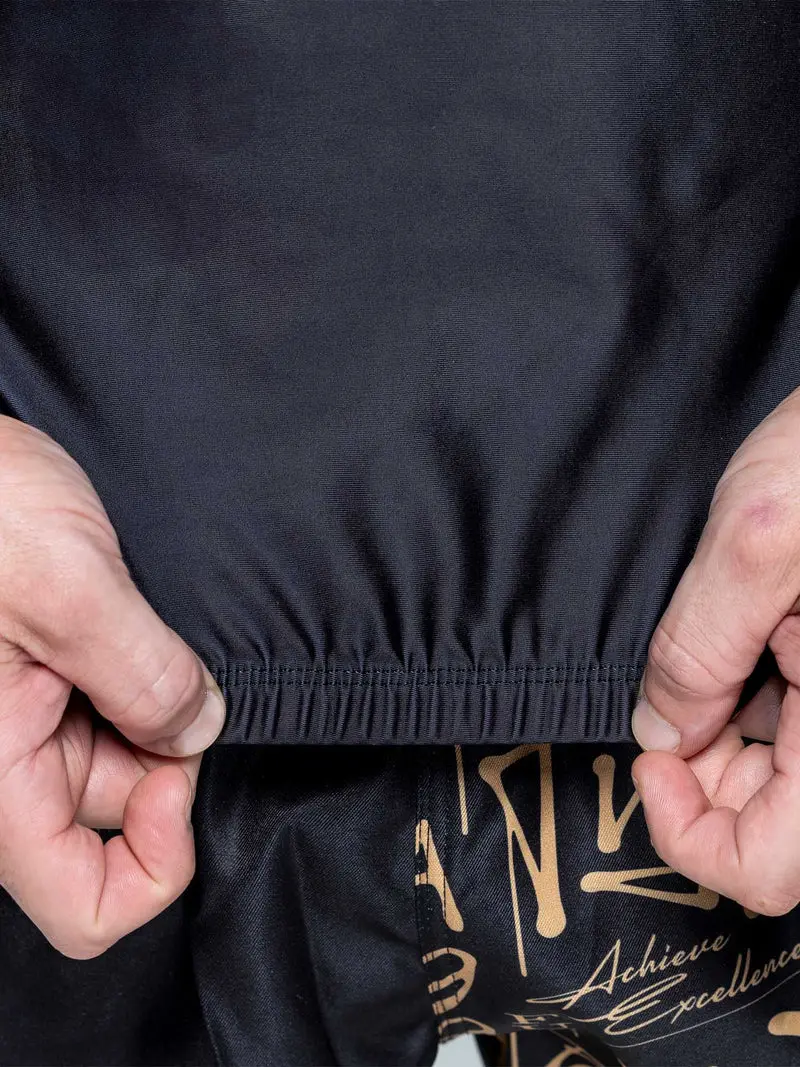 Elastic waist construction on a coordinated black and gold grappling set