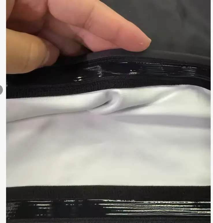 Silicone anti-slip elastic band inside a custom Rash Guard hem