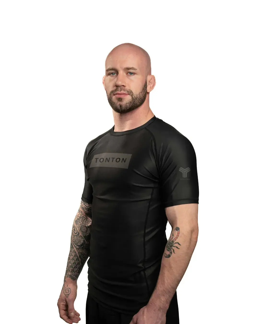 Black short-sleeve custom Rash Guard showing athletic fit, raglan panels and chest branding